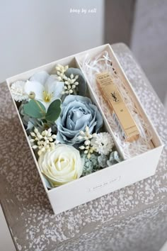 an open box with flowers inside sitting on a table