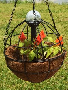 a hanging planter with flowers in it