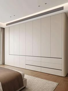 a bedroom with white cabinets and a large bed