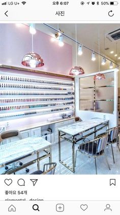 an instagramted photo of a nail salon with pink walls and white counter tops