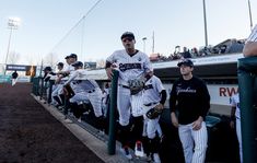 baseball players are lined up in the dugout