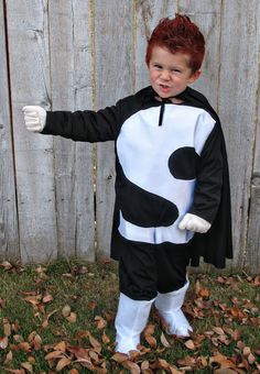 a little boy dressed up in a costume