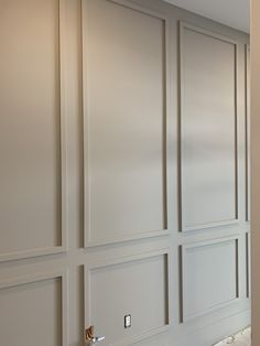 an empty room with white walls and wood trimming on the wall, along with marble flooring