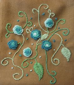 a close up of a cloth with flowers on it and some thread in the middle