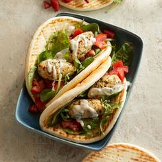 two pita breads filled with meat and veggies