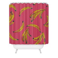 a pink shower curtain with yellow bananas on it