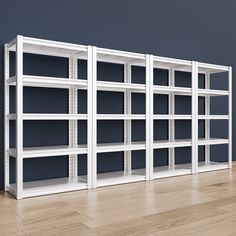 an empty white bookcase on a wood floor