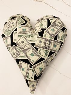 a heart made out of money sitting on top of a counter