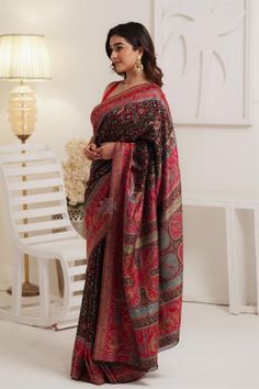 Black Kani saree in silk fabric is very artistically accentuated all over with Kani weaving in traditional motifs like flowers and leaves. Borders and pallu are adorned with motifs of human figures inspired by the Mughal paintings. A hint of zari threads that are woven into the saree accentuate the touch of luxury to this beautiful piece. It is accompanied with Kani booti blouse piece in same colour. The design inspiration for this Pashmina Silk saree is drawn from the heritage weaves of ancient Designer Semi-stitched Jamawar Pre-draped Saree, Designer Kalamkari Print Saree For Eid, Eid Designer Saree With Kalamkari Print, Unstitched Elegant Kalamkari Blouse Piece, Black Jamawar Saree With Pallu, Elegant Multicolor Saree With Kalamkari Print, Elegant Multicolor Kalamkari Print Saree, Elegant Multicolor Kalamkari Saree, Festive Black Jamawar Pashmina Shawl