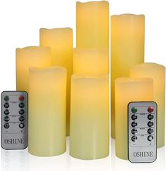 six yellow candles with remote controls in front of each one on a white background,