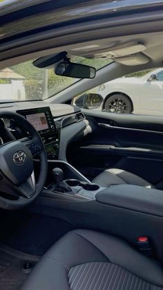 the interior of a car with dashboard, steering wheel and dash board