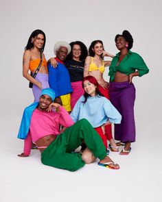 a group of women in colorful clothing posing for a photo