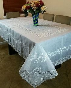 a table with a vase and flowers on it