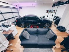 a black car is parked in a garage