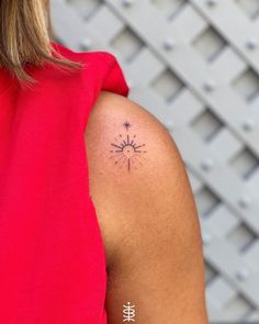 a woman with a tattoo on her arm that has a sun and stars in it