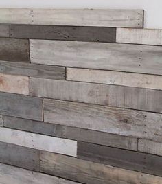 wood planks are stacked on top of each other to create a wall art piece