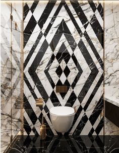 a bathroom with black and white marble walls