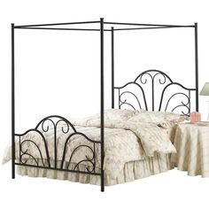 an iron bed frame with a white bedspread