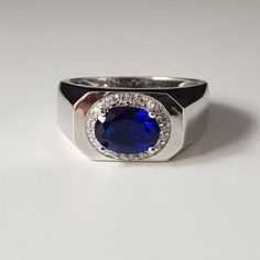 "Description -: Metal - 925 Sterling Silver Stone - ( Lab Created ) Tanzanite Shape - Oval Color - Bluish - Violet Manufacturing - India Stone Size- 7X9MM Tanzanite's deepest shade, Indigo, combines the intuition of the violet ray with the trust of the pure blue ray. It brings wisdom, truth, dignity and spiritual mastery. A stone of judgment and long life, it promotes introspection and can result in profound wisdom when used well. It was eventually named tanzanite in honor of its country of origin. The tanzanite birthstone is often described as \"velvety,\" mostly because of its deep and saturated color, which ranges from a pure rich blue to violet, with the blue considered most valuable." Formal Sterling Silver Signet Ring With Gemstone, Formal Sterling Silver Signet Ring With Center Stone, Formal Sterling Silver Gemstone Rings, Sterling Silver Gemstone Rings For Formal Occasions, Formal White Gold Signet Ring With Gemstone, Silver Signet Ring With Center Stone And Round Cut, Sapphire Signet Promise Ring, Silver Round Cut Signet Ring With Center Stone, Sapphire Signet Ring With Polished Finish