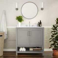 a white bathroom vanity with mirror and plants