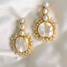 The Amelia dangle pearl earrings are the perfect statement to bring out your feminine, romantic side. Featuring 22ct gold-plated brass, freshwater baroque pearls, and acrylic pearls. Handmade by artisans in India. Limited quantity available. For pierced ears22ct gold plated brassCream baroque pearlsAcrylic pearls Size Dangle Pearl Earrings, Drop Pearl Earrings, Unique Wedding Jewelry, Vintage Statement Earrings, Pearl Statement Earrings, Large Statement Earrings, Pearl Jewelry Design, Pure Heart, Pearl Accessories