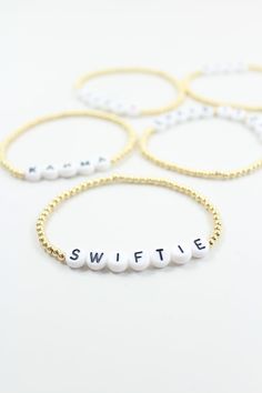 I’m wonderstruck! This Taylor Swift inspired stretchy bracelet is for the minimalist fan who wants a single TS phrase surrounded by gold or silver beads. Pick from ten iconic sayings that will never go out of style. This stretchy bracelet is easy to put on/remove, made with a durable clear stretchy string. Made with the highest quality materials. This bracelet is durable enough for everyday wear and will look beautiful for years to come. Materials: 14k gold filled or sterling silver components o Meaningful Gold Beaded Bracelets As Gift, Meaningful Gold Beaded Bracelets For Gifts, Meaningful Gold Beaded Bracelet As Gift, Meaningful Gold Beaded Bracelet For Gifts, Custom Text Gold Beaded Bracelets For Gifts, Meaningful Gold Bracelets With Round Beads, Personalized Meaningful Stretch Bracelet For Everyday, Gold Beaded Bracelets For Everyday With Meaningful Style, Gold Beaded Bracelets For Everyday Meaningful Style