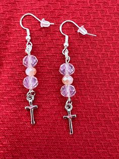 These beautiful lightweight pink/silver beaded earrings are sure to add a colorful accent to any wardrobe!   Attached are adorable crosses with a pink accent stone. All charms are nickel free.   All of my earrings are made with nickel-free, hypoallergenic ear wires.  The earring backs are made of clear silicone. The hooks themselves are 925 sterling silver.   Earrings are approximately 2" in length from the top of the ear wires to the bottom of the earring rings.  All of my earrings are pretty a Pink Crystal Dangle Earrings With Ear Wire, Handmade Pink Crystal Earrings In Sterling Silver, Handmade Pink Crystal Sterling Silver Earrings, Nickel-free Pink Beaded Earrings, Pink Beaded Drop Crystal Earrings, Pink Beaded Crystal Drop Earrings, Nickel-free Pink Round Beaded Jewelry, Nickel Free Pink Dangle Beaded Earrings, Nickel Free Pink Round Bead Earrings