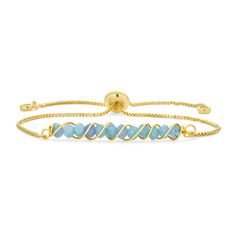 Here's a new twist on the on gemstone bracelet, Our tourmaline gold plated brass adjustable bracelet showcases a neat and sparkling row of wire twisted gems, secured by a box chain that lends a modern, contemporary, clean look. With lariat styling rubber lining to hold the bracelet's fit firm, this bracelet adjusts from 6 inches to 9 inches in length to fit nearly any wrist. Adjustable Yellow Gold Bracelets With A Modern Twist, Adjustable Yellow Gold Beaded Bracelet With Gemstones, Adjustable Bracelets With A Modern Twist As A Gift, Adjustable Gold Plated Beaded Bracelets, Adjustable Gold Beaded Gemstone Bracelets, Adjustable Yellow Gold Gemstone Beaded Bracelets, Adjustable Bracelets As Gift With A Modern Twist, Adjustable Modern Twist Bracelet As Gift, Elegant Blue Bracelet With Adjustable Length