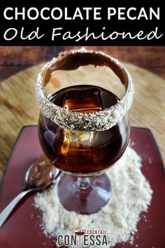 chocolate pecan old fashioned cocktail in a goblet garnished with powdered sugar