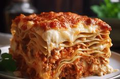 a close up of a plate of lasagna with meat and cheese on it