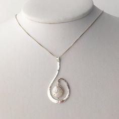 This sterling silver pendant was hammered to shape to wrap around a baroque pearl.  The coin shaped pearl has just under a 1/2" diameter.  The pendant is 7/8" wide and 1 3/4" long.  The pendant is on a sterling silver .85 mm box chain. Hammered Pearl Jewelry Gift, Unique Silver Pearl Drop Necklace, Elegant Sterling Silver Swirl Necklace, Elegant Spiral Hand Forged Jewelry, Elegant Hand Forged Spiral Jewelry, Simple Pearl Pendant, Baroque Pearl Pendant, Spiral Pendant, Hammered Bangles