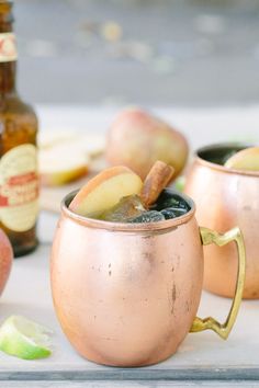 two copper mugs filled with apple cider punch