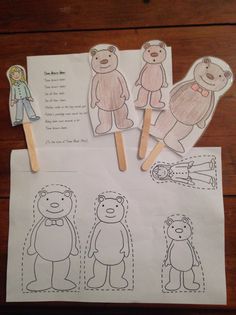 four bear cut outs on top of paper with toothpicks in front of them