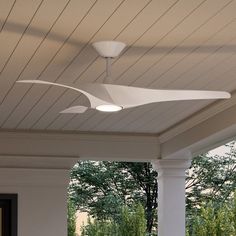 the ceiling fan is attached to the roof of this porch with white columns and pillars