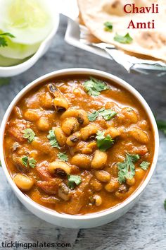 a white bowl filled with chickpeas and garnished with cilantro