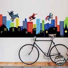 a bicycle parked in front of a wall with superheros and cityscape on it