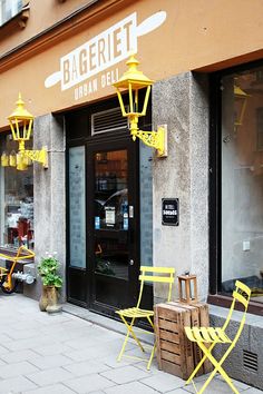 two yellow chairs sitting outside of a restaurant