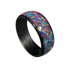 * THE RING - Carbon Fiber Ring with Nebula Opal inlay in a high gloss finish. This ring has a traditional rounded band, Nebula opal inlay, and a high gloss finish. The opal inlay is infused with glow powder and will glow an aqua color. Each ring is individually handcrafted giving you a one of a kind piece.  PRIMARY COLORS: Pink, Blue, Purple SECONDARY COLORS: Yellow, Green * SIZING- All of our rings are made according to US Sizing and are standard fit. Please keep in mind, the band width can affect how the ring will fit. The wider band widths will sit on the fattier part of the finger making it feel tighter. We recommend with a 9mm or 10mm band width you go up half size from what you normally wear.  * PROPRIETARY NASA TECHNOLOGY IN EVERY RING - Having decades of experience with carbon fibe Black Opal Round Jewelry, Black Ring With Inlay, Black Rings With Inlay, Black Inlay Round Ring, Black Oval Opal Jewelry, Oval Black Opal Jewelry, Round Enamel Ring With Inlay, Carbon Fiber Rings, Opal Band