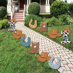 cowboy themed yard decorations in front of a house