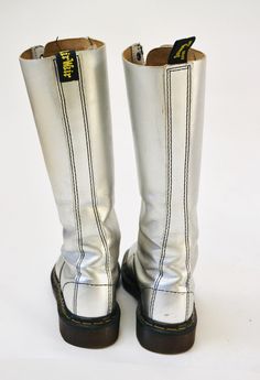 "Made in England by Dr. Martens Made in England by Dr. Martens Silver metallic leather Print Combat boots Size -VTG Size 4 UK US Womens aprx 6 Leather upper Rubber souls 10 3/8\" length outer sole 9 1/8\" length inner sole 4\" width outer sole 3 3/4\" width inner sole Shaft Height 12 1/2\" from heel Used Vintage condition with below points * wear/scuffs on outside of shoe where the silver has worn * Some wear on the inside of the insoles * Some wear on the soles * Lots of life in them! Price is Silver Leather Knee-high Boots, Silver Fitted Knee-high Boots, Dr Martens Boots Women, Lace Up Knee High Boots, Silver Boots, Doc Marten, Martens Boots, Boots Vintage, Sequin Pants