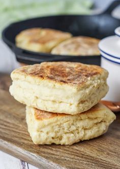 two pancakes stacked on top of each other in front of a skillet and pan