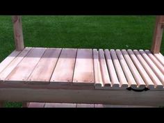 a wooden bench sitting on top of a lush green field