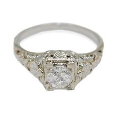 an antique style diamond ring with filigrees