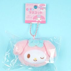 a pink stuffed animal with a blue bow on it's head in a plastic bag