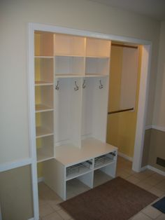 an empty room with closets and shelves in it