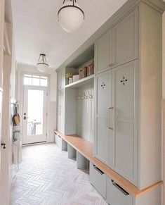 an empty room with many cupboards and shelves on the wall next to a door