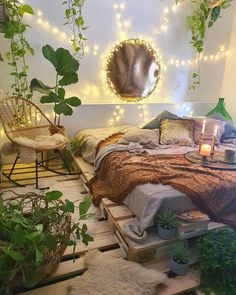 a bedroom with lots of plants and lights on the wall