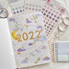 a notebook with the number 22 on it next to some scissors and other items that are also part of a planner