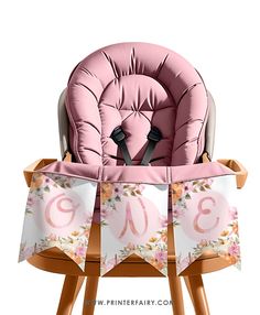 a pink baby seat sitting on top of a wooden chair