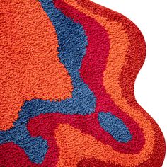 an orange rug with blue and red designs on the bottom, against a white background